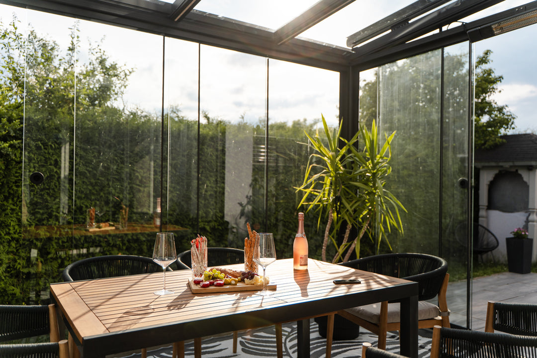 a table set underneath an anthracite conservatory