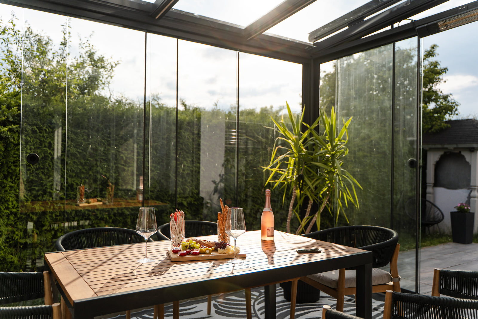 a table set underneath an anthracite conservatory